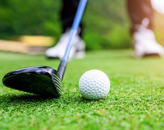 Close up of a golf ball and club