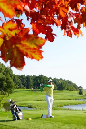 Golfer playing on driving range during the fall