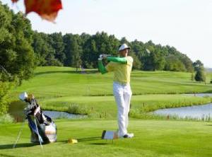 Golfer playing on driving range during the fall