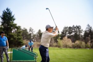 People practicing hitting golf balls on driving range