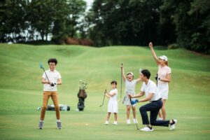 Family at golf course celebrating shot